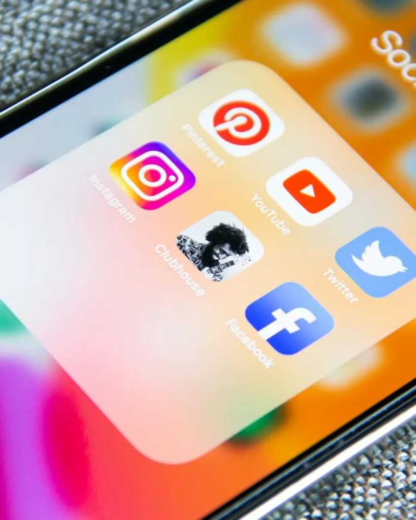 Smartphone home screen showing a folder of social media apps including Facebook and Instagram