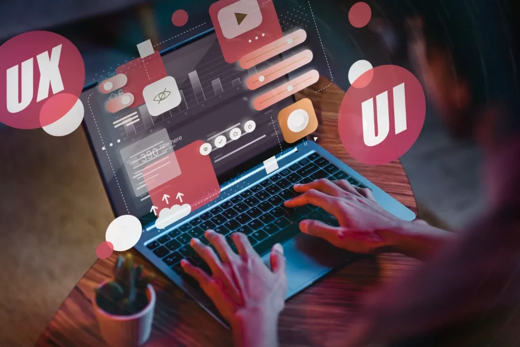 Designer working on website UX and UI layouts on a laptop, web design for Cambridge businesses