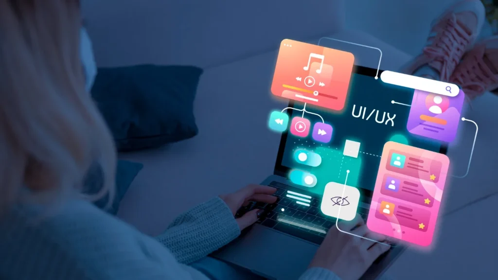 Designer working on website UI and UX layouts on a laptop, web design for Ipswich businesses